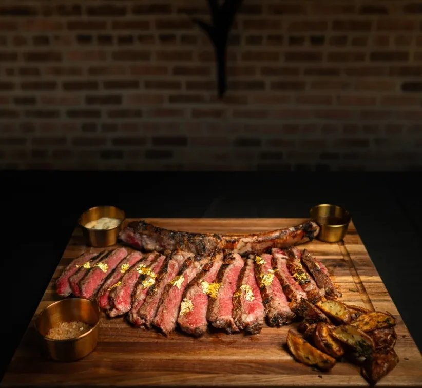 A tomahawk steak, sliced and resting.