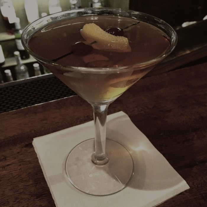 A manhattan served up with a brandied cherry.