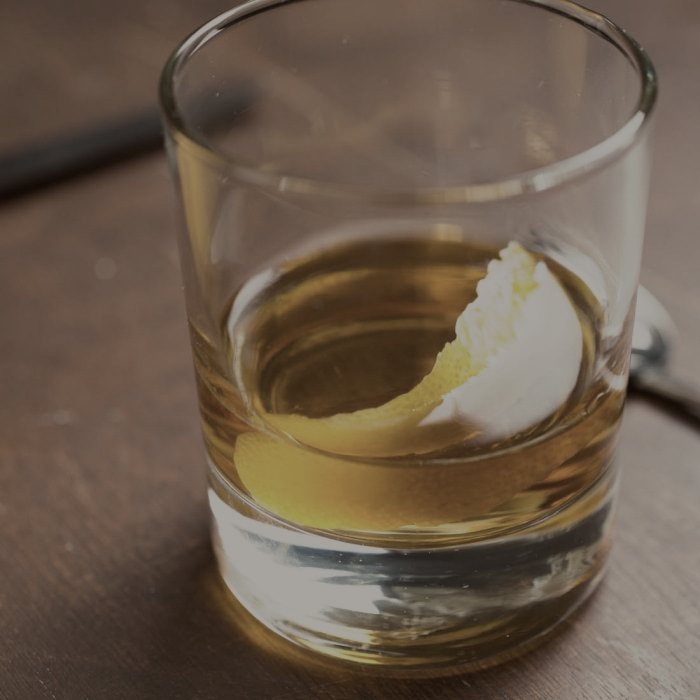 A sazerac served up in a rinsed rocks glass.